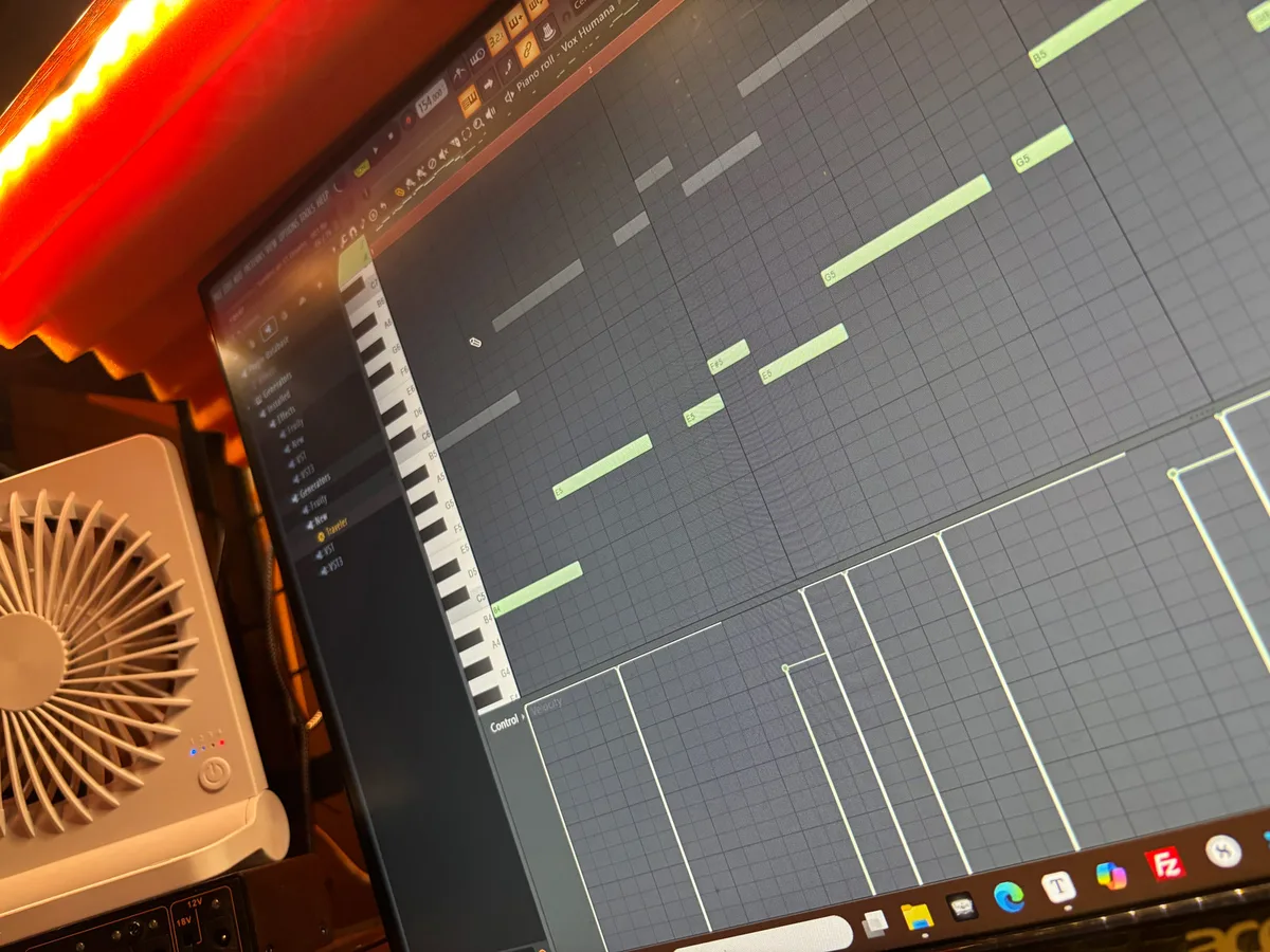 A DAW piano roll on a studio monitor, showing green MIDI notes for a track called “Vox Humana” laid out along a virtual keyboard.